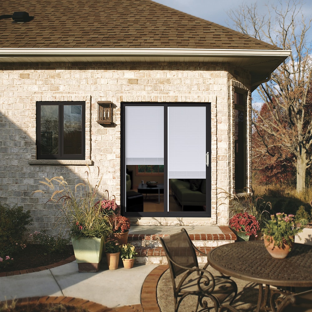 JELD-WEN FiniShield V-2500 72-in x 80-in, 4-9/16-in Jamb Bronze Vinyl Right-Hand Sliding Double Patio Door with Low-E Argon Glass and Screen