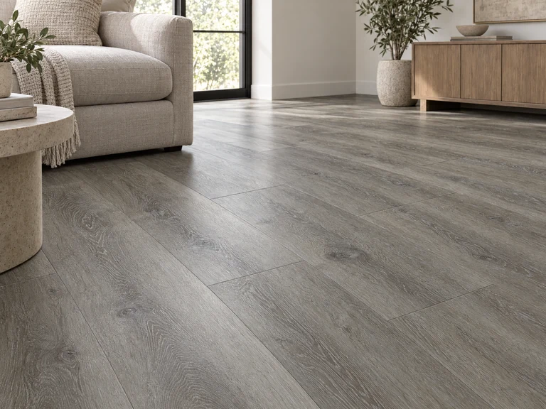 Gray wood-look planks with staggered joints across a sunlit living room floor