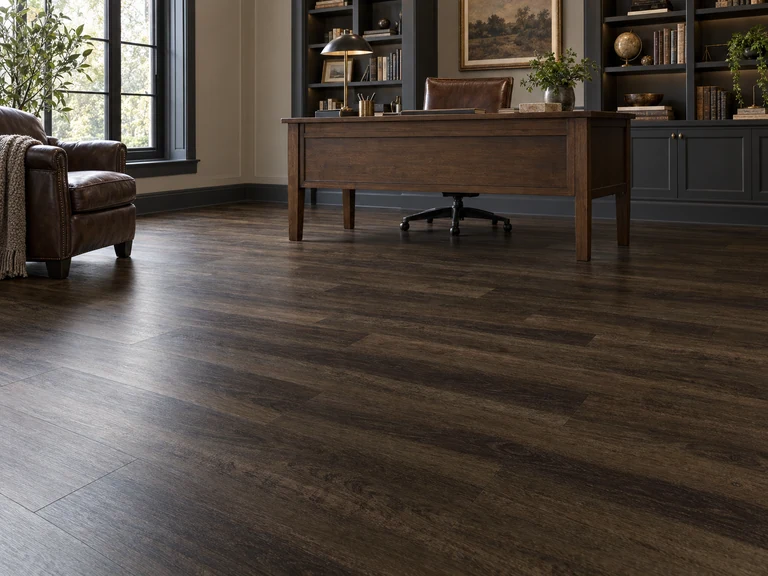Dark walnut-look planks across a quiet home office floor